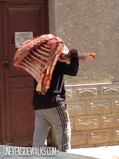 Man Carrying a Quarter of beef on his shoulder
